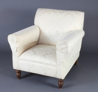 A Victorian Howard style armchair upholstered in white material 