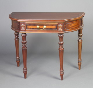 A Victorian style shaped mahogany and crossbanded side table fitted a drawer, raised on turned and fluted supports 75cm x 97cm x 47cm 