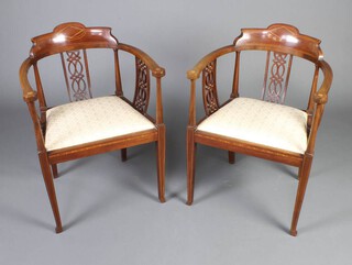 A pair of Edwardian inlaid mahogany tub back chairs with upholstered drop in seats, raised on square tapered supports 