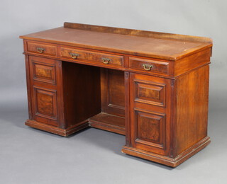An Edwardian walnut dressing table/desk with raised back fitted 1 long and 2 short drawers above cupboards fitted trays enclosed by panelled doors 81cm h x 139cm w x 51cm d 