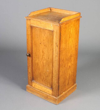 A Victorian pine pot cupboard with 3/4 gallery, the interior fitted a shelf enclosed by a panelled door, raised on a platform base 78cm h x 38cm w x 34cm d 