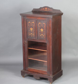A Victorian inlaid rosewood music cabinet with raised back enclosed by an inlaid and glazed door 110cm h x 57cm w x 34cm d 