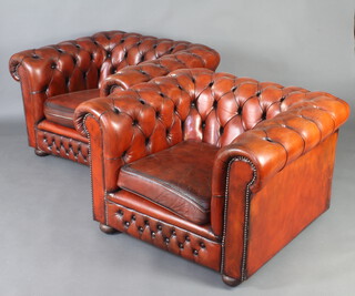 A pair of Chesterfield style armchairs upholstered in light brown buttoned leather 
