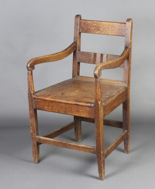 An 18th/19th Century elm bar back carver chair with solid seat raised on square supports with box framed stretcher 