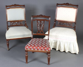 A pair of Edwardian carved and pierced walnut nursing chairs with upholstered seats and backs raised on turned supports together with a salon chair upholstered in different material (frame is loose) 