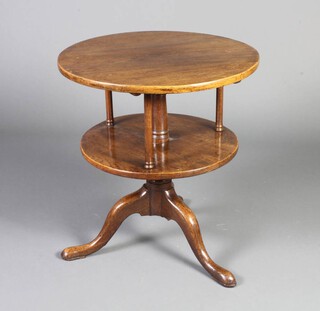 An 18th Century style circular oak 2 tier revolving occasional table raised on a pillar and tripod base 66cm h x 61cm diam. 