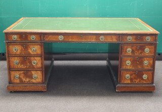 A Victorian mahogany partners desk with inset tooled green leather writing surface, above 2 long and 18 short drawers with brass ring drop handles 76cm h x 183cm w x 117cm d 