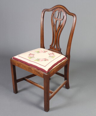 A 19th Century mahogany Hepplewhite style came back dining chair with Berlin woolwork upholstered drop in seat, raised on square tapered supports with H framed stretcher 