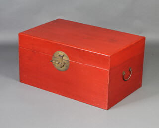 A Chinese red lacquered coffer with gilt lock and drop handles to the side 39cm x 78cm x 49cm 