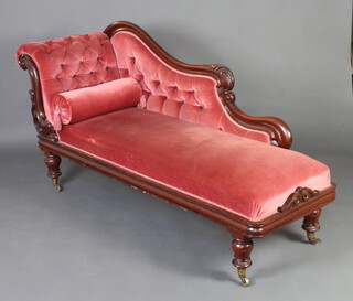 A Victorian carved mahogany show frame chaise longue upholstered in rose pink buttoned Dralon, raised on turned supports 93cm h x 201cm w x 60cm d 