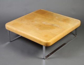 Heals, a mid 20th Century square bleached oak and chrome coffee table, raised on chrome supports 31cm h x 88m w x 89cm d, the base with Heals paper label marked 196 Tottenham Court Road, 230/302 0CC Table 