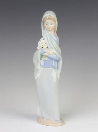 A Lladro figure of a lady holding lilies 4650 23cm 