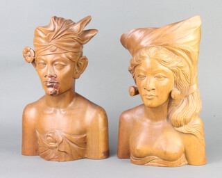 A pair of Bali carved hardwood head and shoulders portraits busts of a lady and gentleman, bases marked Klungkung Bali 32cm h x 20cm w x 10cm d 