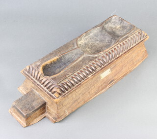 A rectangular "gavel" stand of wedge form with brick decoration, marked Recovered from Tura Caves November 1943 10cm x 39cm w x 15cm d 