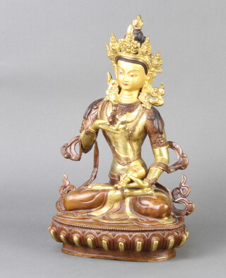 An Eastern gilt bronze and cold painted figure of a seated deity 30cm h x 18cm w x 13cm d 