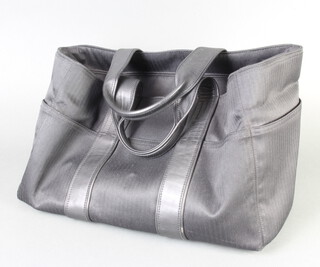 Hermes, a black fabric and leather handled Acapulco travel bag with chrome zip and 8 exterior pockets, 24cm x 37cm x 20cm, interior zip marked Hermes and also tagged Hermes to the interior pocket  