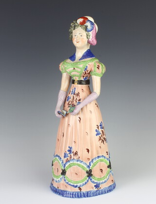 An English porcelain figure of a lady holding a flower and a book 33cm 