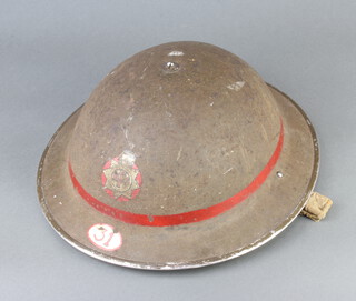 A World War Two National Fire Service leading fireman's steel helmet marked 31, the interior marked 721898 L/FM Pankhurst