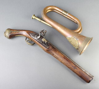 A reproduction flintlock pistol with 29cm barrel together with a reproduction copper and brass bugle 