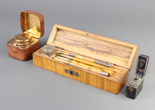 A Victorian leather and gilt travelling inkwell 5cm x 5cm x 5cm, 1 other 4cm x 4cm x 2cm and a wooden pencil case containing various dip pens (hinge to case f) 