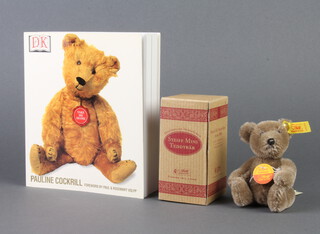 A Steiff figure of a racoon 10cm, a Steiff XS teddy bear 1998 6cm boxed and  Pauline Cockril "The Bear Encyclopedia" 