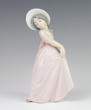 A Lladro figure of a girl wearing a bonnet 19cm 