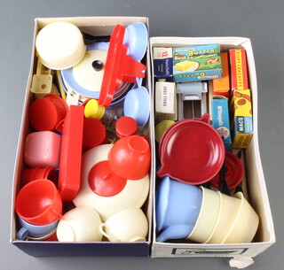 A collection of 1960's plastic dolls house utensils including plates, tea pot and various cardboard cartons 
