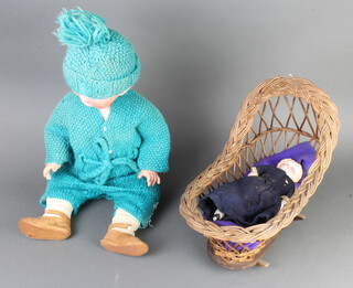 A Victorian Continental doll with porcelain head, shoulders and legs and fabric body, contained in a wicker work holdall, together with a German porcelain headed doll with shutting eyes and open mouth the head incised 317 7 Germany 
