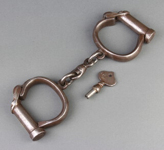 A pair of Warranted Rough, Darby style, police handcuffs complete with key, marked Warranted Rough AM P4/1407 1939, key and cuffs marks 110 
