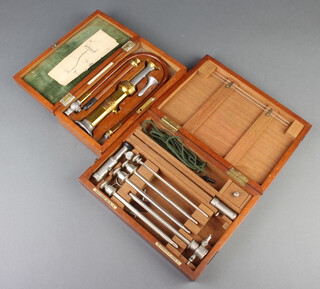 An Arnold and Sons Simplex "enema" boxed, and 1 other medical instrument by Genito-Urinary Manufacturing Company Ltd boxed 