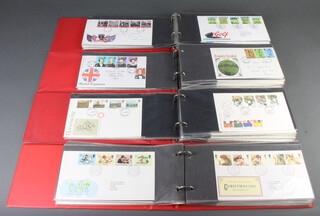 Four red albums of Elizabeth II GB first day covers 