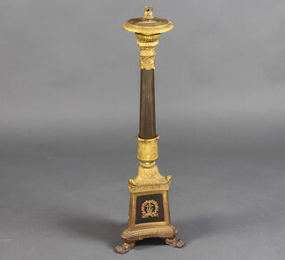 A gilt ormolu Empire style reeded column table lamp raised on a triform base with paw feet 72cm h x 22cm w x 22cm d 