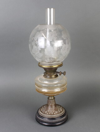 A Victorian faceted clear glass oil lamp raised on a pierced metal frame with etched glass shade