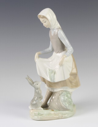 A Lladro figure of a young lady with a rabbit at her feet no.4326, 22cm 