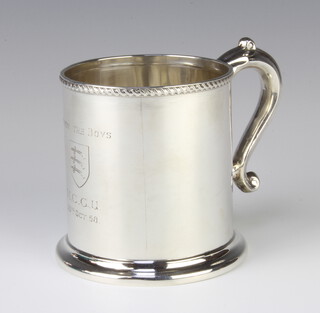 A Victorian silver mug of plain form with beaded rim and engraved inscription with S scroll handle 203 grams 