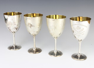 Four Edwardian silver cups with presentation inscription to the South London Harriers, Sheffield 1900, 1902, 1906 and 1907, with gilt interiors, 570 grams 