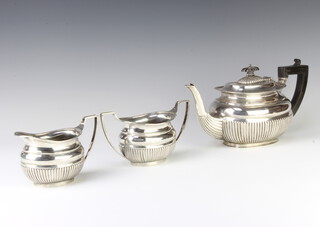 A silver 3 piece demi-fluted tea set with ebony mounts, Sheffield 1925, maker Mappin and Webb, gross weight 564 grams 
