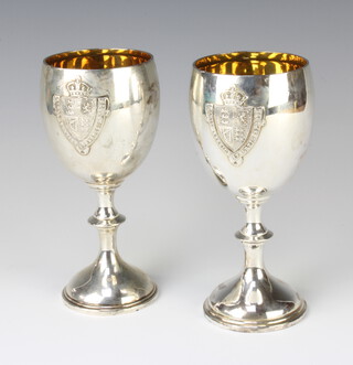 Two Edwardian silver presentation cups with applied armorial decoration, London 1904 and 1906, 305 grams 
