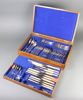 An Edwardian oak canteen containing a quantity of matched plated cutlery 