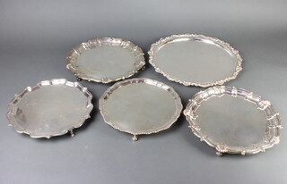 A silver plated Chippendale style salver 27cm and 4 others 