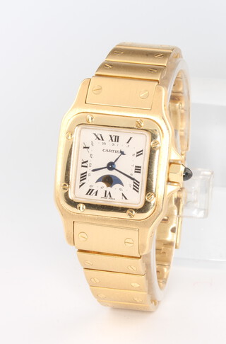 Cartier, a lady's 18ct yellow gold Cartier Santos Galbee moon phase wristwatch with subsidiary calendar and visible moon phase on an 18ct yellow gold strap, with blue sapphire winder, numbered 8199020176, contained in a Cartier pouch 