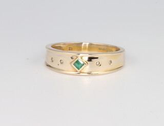 A 9ct yellow gold emerald and diamond set ring, size M, 2 grams