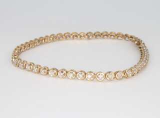A 9ct yellow gold diamond set tennis bracelet 18cm, 5.7 grams 