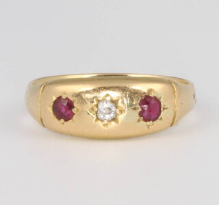 An 18ct yellow gold ruby and diamond 3 stone ring, size I, 2.6 grams 