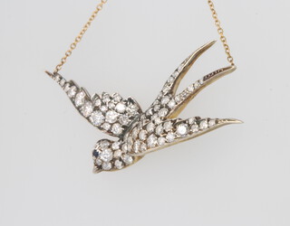 An Edwardian style diamond and sapphire swallow pendant 2.2ct, 50mm, on an 18ct yellow gold chain 