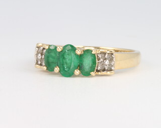 A 14ct yellow gold emerald and diamond ring, size N, 2.8 grams