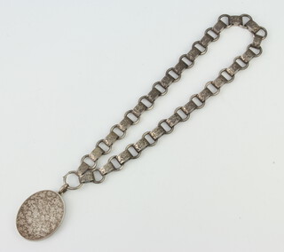 A chased silver locket and chain 74 grams