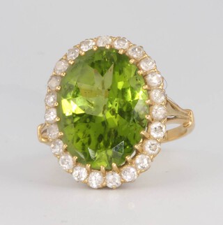 An 18ct yellow gold peridot and diamond cluster ring 20mm x 15mm, size N 