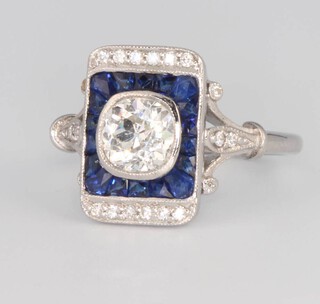 An 18ct white gold Art Deco style sapphire and diamond ring, the centre cushion cut diamond approx. 0.92ct, size M 