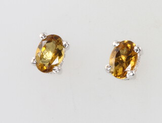 A pair of silver and orange tourmaline ear studs 